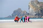 Family running together on beach