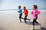 Family running on beach