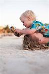 Mother and toddler son playing on beach