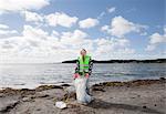 Girl in safety vest cleaning beach