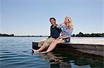 Couple relaxing together on dock