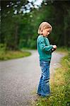 Girl walking along rural road