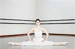 Ballet dancer doing splits in studio