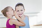 Ballet dancers whispering in studio