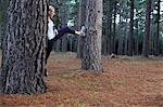 Runner stretching in forest