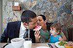 Couple sharing watermelon at breakfast