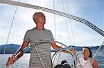 Older couple relaxing on sailboat