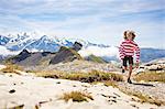 Boy running in rocky landscape