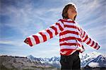 Boy standing in rocky landscape