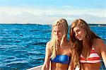 Teenage girls relaxing on sailboat