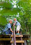 Father and son building treehouse