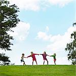 Girls playing tug-of-war in field