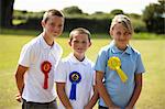 Children wearing ribbons in field