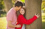 Teenage couple hugging in park
