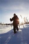 Cross-country skier walking in snow