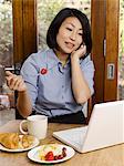 Businesswoman eating and working