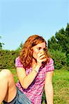 Teenage girl drinking juice in backyard
