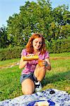 Teenage girl drinking juice at picnic