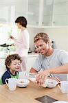 Family eating breakfast in kitchen