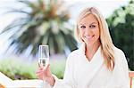 Woman in bathrobe relaxing outdoors