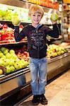 Boy holding fruit at grocery store