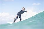 Teenage surfer riding a wave