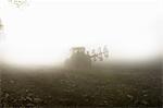 Tractor driving through fog