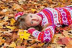 Woman laying in fall leaves