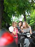 Women applying makeup in side mirror