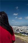 Woman on hill overlooking cityscape