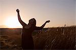 Woman standing in wheat field