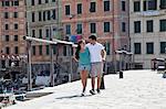Couple walking along urban pier