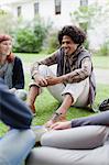 Students talking on grass on campus