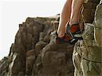 Rock climbers feet on steep rock face