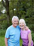 Older couple laughing together in park