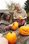 Mother and daughter carving pumpkins