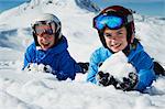 Children making snowballs on mountain