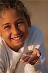 Smiling girl holding seashell