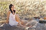 Woman picnicking in wheatfield