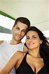 Smiling couple relaxing on boat