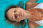 Woman floating in swimming pool