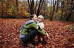 Mother and son in autumn leaves