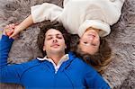 Couple relaxing together on rug