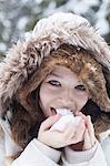 Teenage girl licking snowball