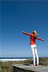 Woman standing on wooden pier