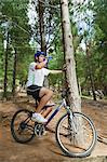 Mountain biker drinking water in forest