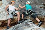 Climbers scaling steep rock face