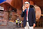 Businessman using walkie talkie on site