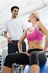 Smiling couple talking in gym