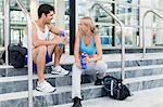 Couple talking on gym steps